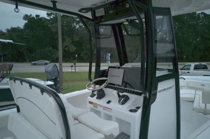 Slide: The Image of 2026 Seahunt 245 boat cockpit with Garmin navigation system and modern steering console. - 9