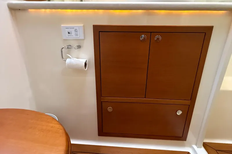 Slide: The Image of 2017 Grand Banks 44 Eastbay SX interior with wooden cabinetry and wall-mounted accessories. - 101