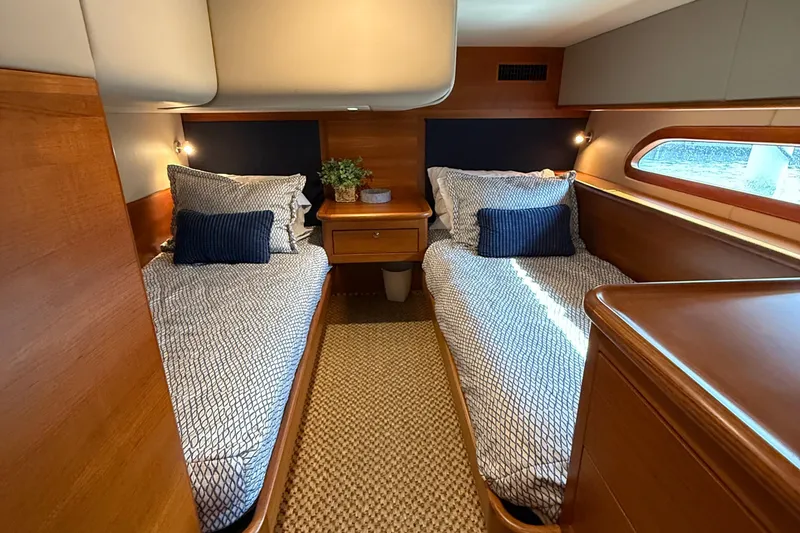 Slide: The Image of 2017 Grand Banks 44 Eastbay SX cabin with twin beds, elegant wood finish, and nautical decor. - 108