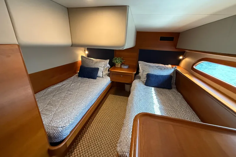 Slide: The Image of 2017 Grand Banks 44 Eastbay SX cabin with twin beds and wooden interior. - 109
