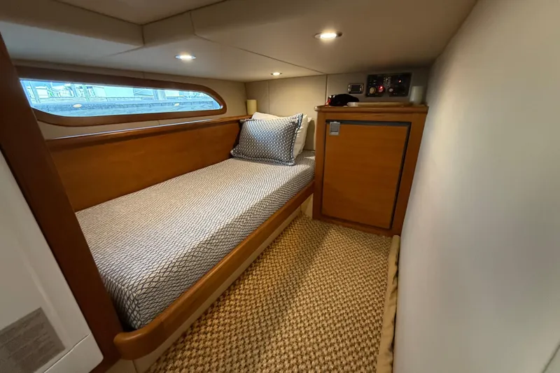 Slide: The Image of 2017 Grand Banks 44 Eastbay SX cabin with single bed and wooden cabinetry. - 117