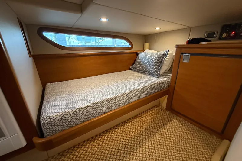 Slide: The Image of Cozy cabin interior of 2017 Grand Banks 44 Eastbay SX with wooden finish and bed. - 118
