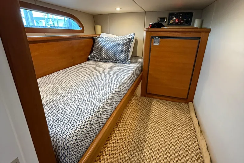 Slide: The Image of 2017 Grand Banks 44 Eastbay SX cabin with single bed and wooden cabinetry. - 119