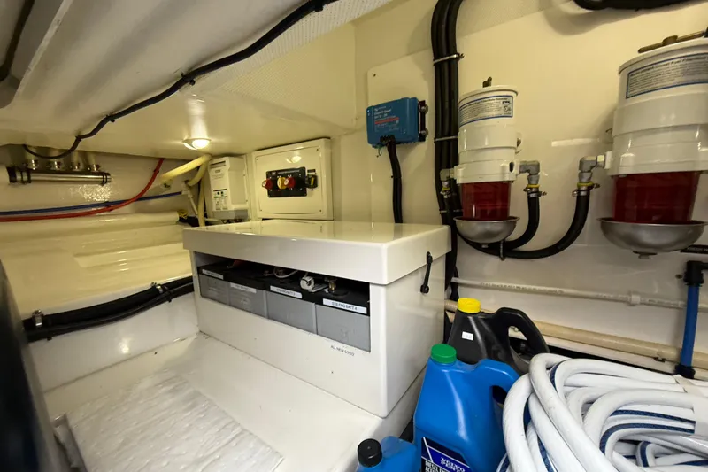 Slide: The Image of Engine room of 2017 Grand Banks 44 Eastbay SX with fuel filters and maintenance supplies. - 128