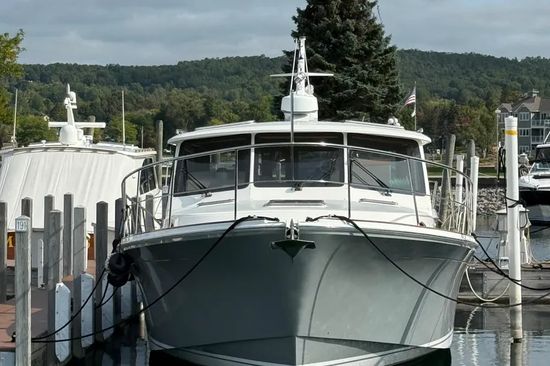 Slide: The Image of 2017 Grand Banks 44 Eastbay SX yacht docked at a marina with scenic background. - 130