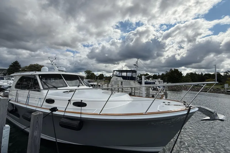 Slide: The Image of 2017 Grand Banks 44 Eastbay SX yacht docked at marina under cloudy sky. - 19