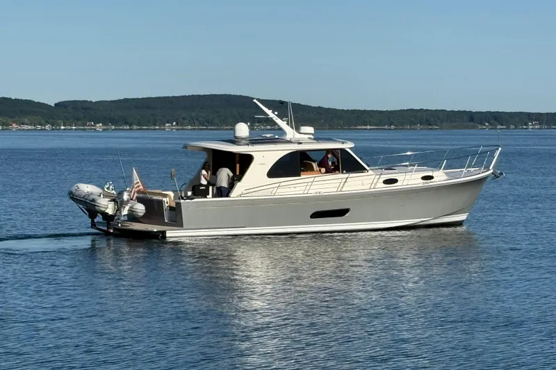 Slide: The Image of 2017 Grand Banks 44 Eastbay SX yacht cruising on a serene lake. - 2