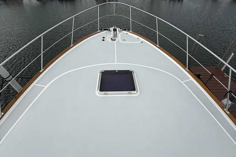 Slide: The Image of 2017 Grand Banks 44 Eastbay SX yacht anchored in a serene marina setting. - 23