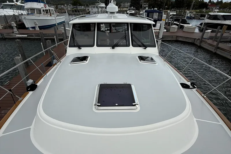 Slide: The Image of 2017 Grand Banks 44 Eastbay SX with solar panels docked at a marina. - 27