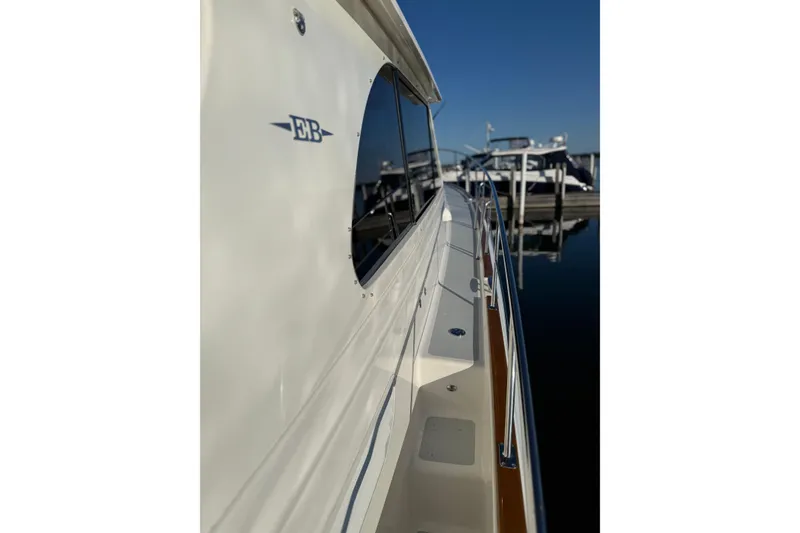 Slide: The Image of Luxurious 2017 Grand Banks 44 Eastbay SX yacht with elegant deck seating and striped cushions. - 33