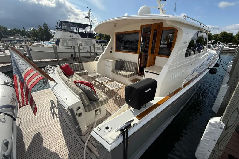 Slide: The Image of Luxurious 2017 Grand Banks 44 Eastbay SX yacht with elegant deck seating and marina view. - 36