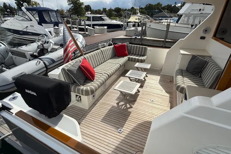 Slide: The Image of Luxurious 2017 Grand Banks 44 Eastbay SX yacht interior with seating and wooden accents. - 37