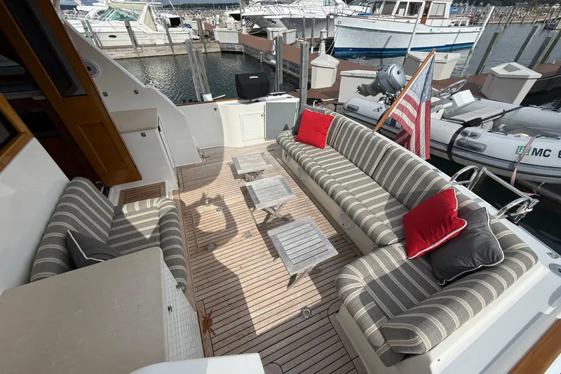 Slide: The Image of 2017 Grand Banks 44 Eastbay SX yacht with striped seating and wooden deck. - 39