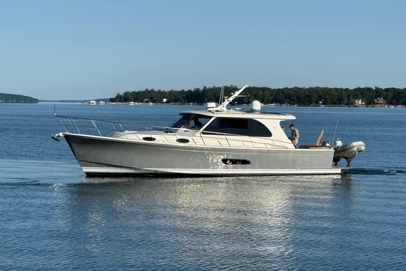 Slide: The Image of 2017 Grand Banks 44 Eastbay SX yacht cruising on a serene lake. - 4