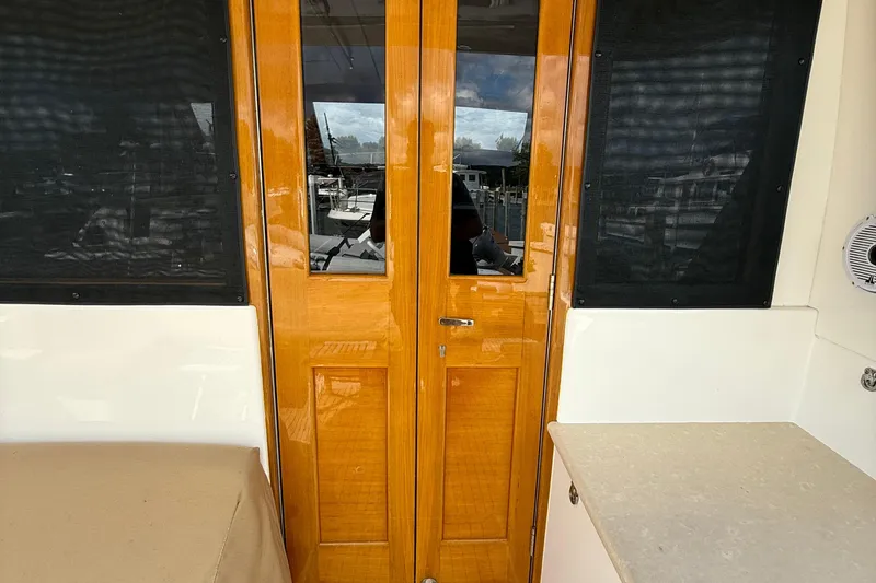 Slide: The Image of Luxurious interior of 2017 Grand Banks 44 Eastbay SX yacht with elegant seating and wooden table. - 50