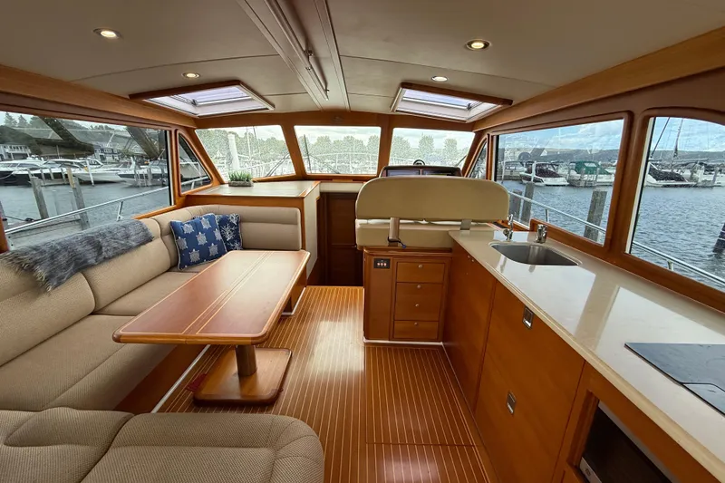 Slide: The Image of Luxurious interior of 2017 Grand Banks 44 Eastbay SX yacht with plush seating and wooden table. - 51