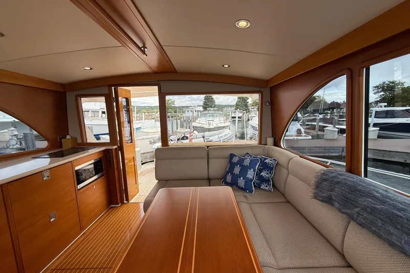 Slide: The Image of 2017 Grand Banks 44 Eastbay SX yacht interior with modern kitchen and scenic marina view. - 59