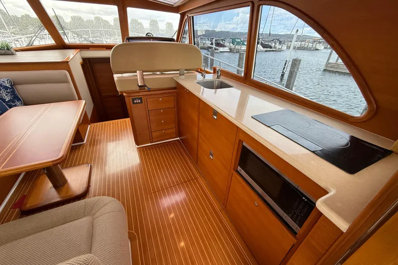 Slide: The Image of 2017 Grand Banks 44 Eastbay SX yacht interior with stainless steel sink and marina view. - 60