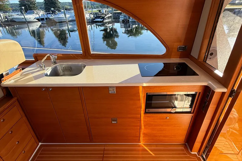Slide: The Image of Wooden cabinetry and battery switches on 2017 Grand Banks 44 Eastbay SX yacht interior. - 63