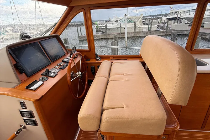 Slide: The Image of Helm of 2017 Grand Banks 44 Eastbay SX with navigation screens and controls. - 74
