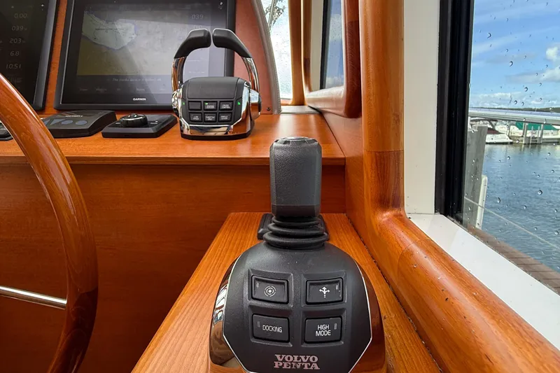 Slide: The Image of 2017 Grand Banks 44 Eastbay SX interior with wood finish, showing hallway, bathroom, and bedroom. - 82