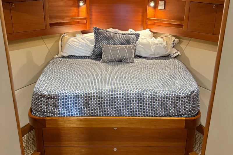 Slide: The Image of Cozy bedroom interior of 2017 Grand Banks 44 Eastbay SX yacht with wooden accents. - 87