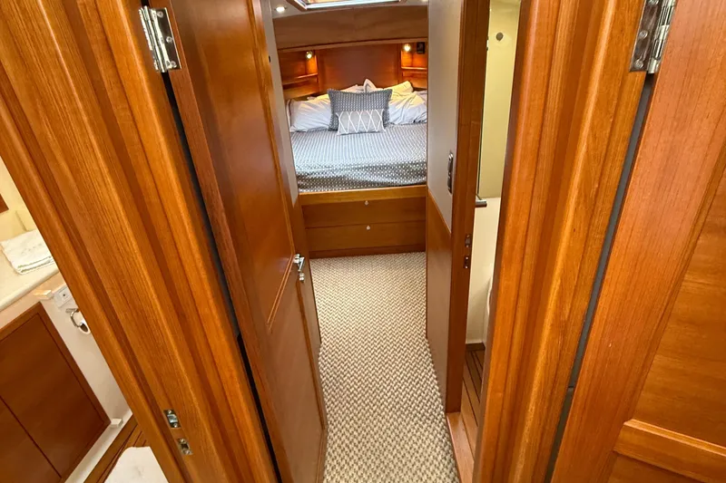 Slide: The Image of Luxurious cabin interior of 2017 Grand Banks 44 Eastbay SX yacht, featuring cozy bedding and wood finishes. - 88