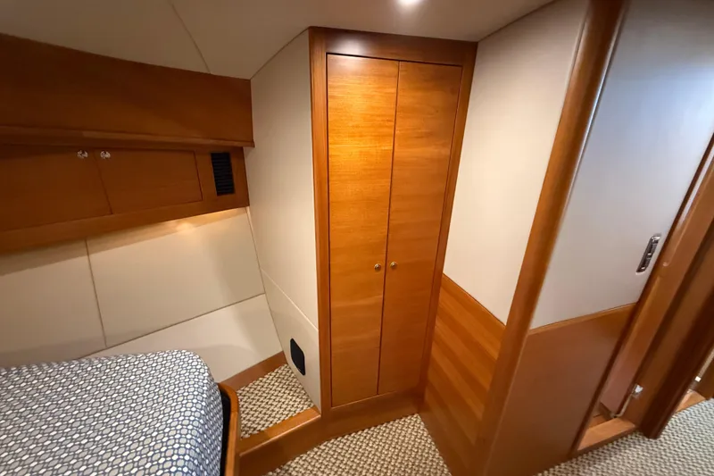 Slide: The Image of 2017 Grand Banks 44 Eastbay SX cabin interior with wooden closet and bed. - 94