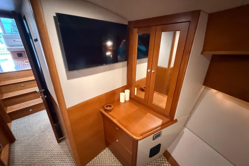 Slide: The Image of Luxurious interior of 2017 Grand Banks 44 Eastbay SX yacht with wooden cabinetry and TV. - 98