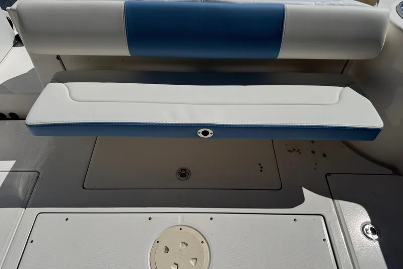 Slide: The Image of 2023 Robalo R302 Center Console boat seating area with blue and white upholstery. - 10