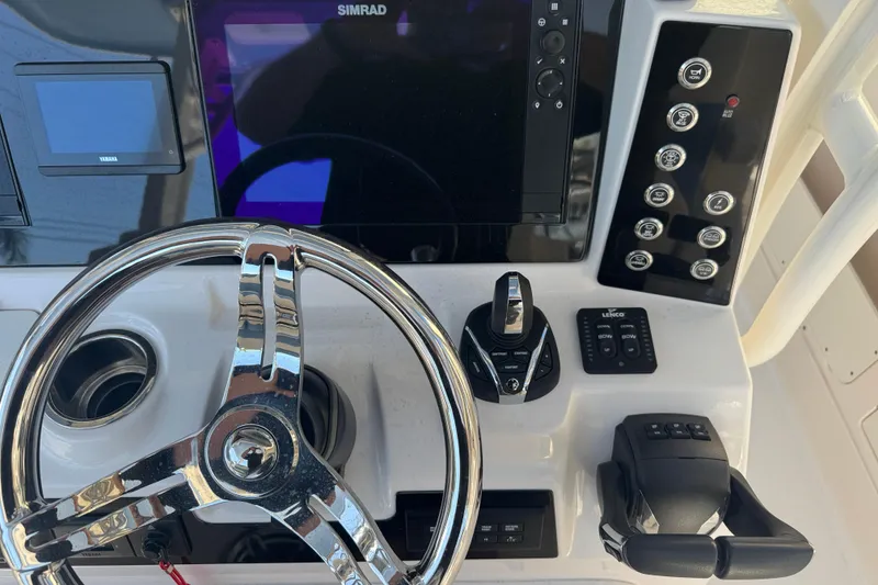 Slide: The Image of 2023 Robalo R302 Center Console dashboard with steering wheel and electronic controls. - 11