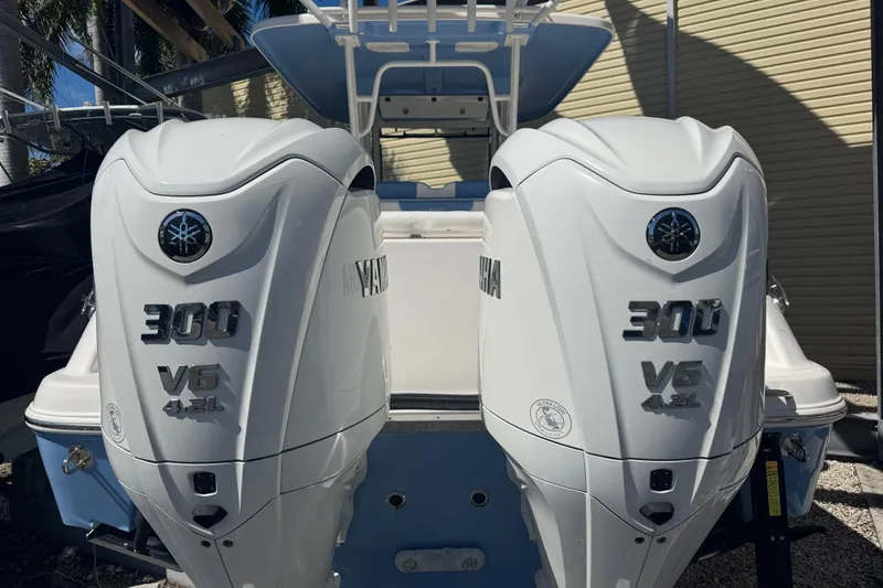 Slide: The Image of 2023 Robalo R302 Center Console with twin Yamaha 300 V6 outboard engines. - 2