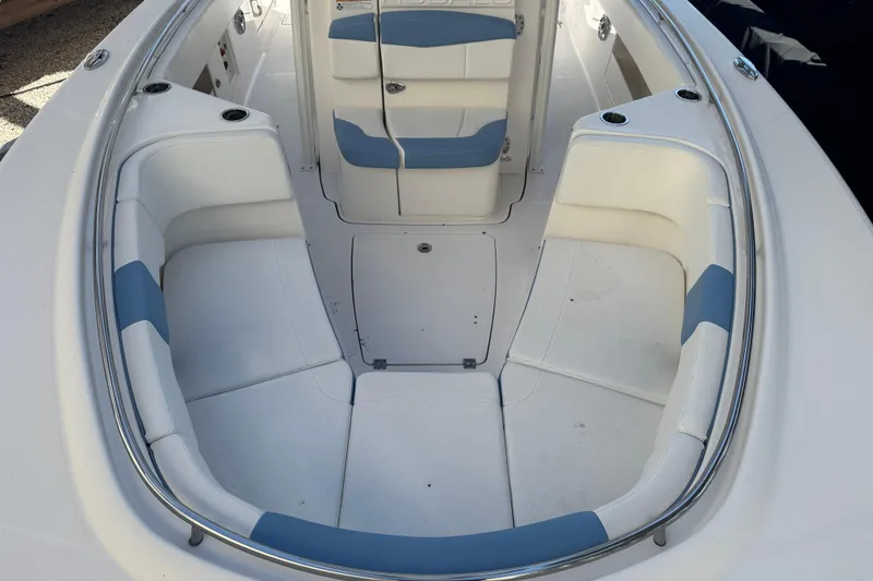 Slide: The Image of 2023 Robalo R302 Center Console boat interior with white and blue seating. - 22