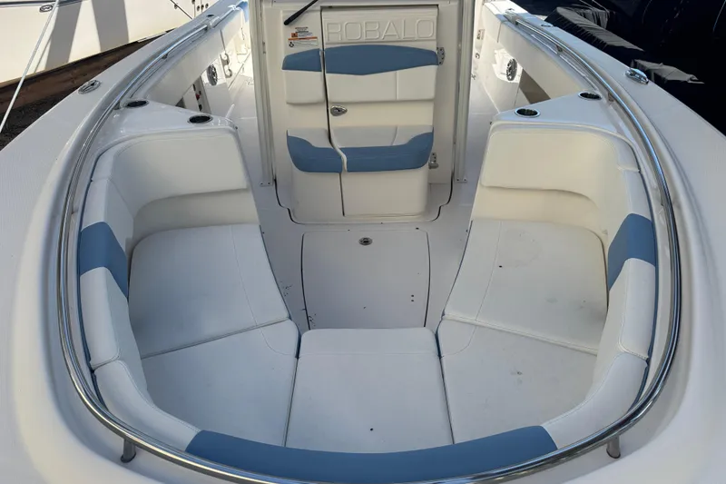 Slide: The Image of 2023 Robalo R302 Center Console boat interior with white and blue seating. - 23