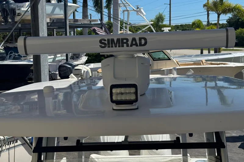 Slide: The Image of 2023 Robalo R302 Center Console with Simrad radar on top. - 24