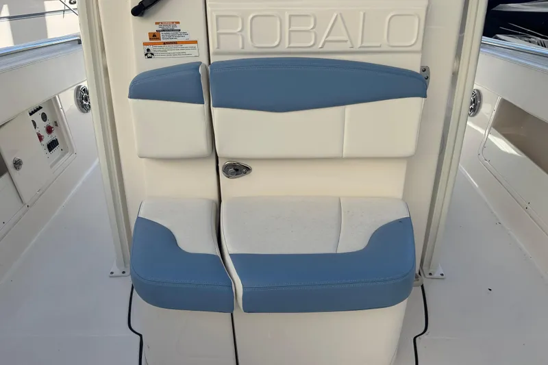 Slide: The Image of 2023 Robalo R302 Center Console boat seat with blue and white upholstery. - 25