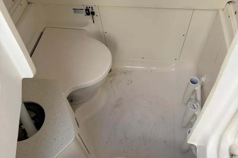 Slide: The Image of 2023 Robalo R302 Center Console boat interior with toilet and sink. - 26