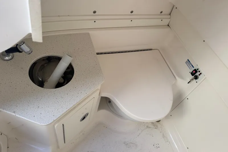 Slide: The Image of 2023 Robalo R302 Center Console boat interior with sink and toilet. - 27