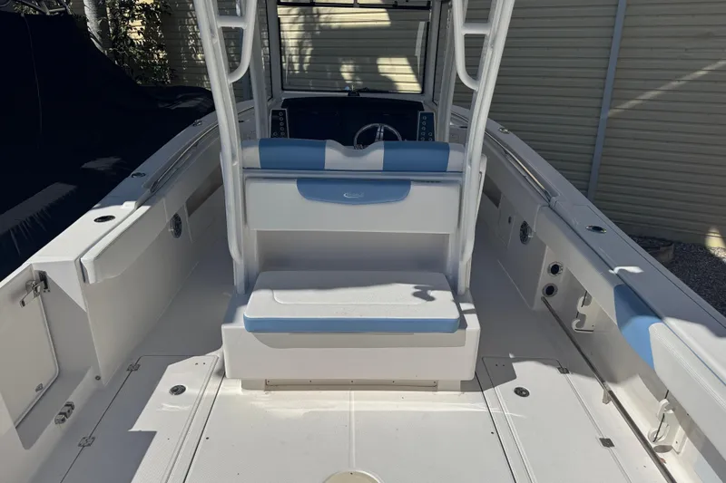 Slide: The Image of 2023 Robalo R302 Center Console boat interior with seating and console view. - 4