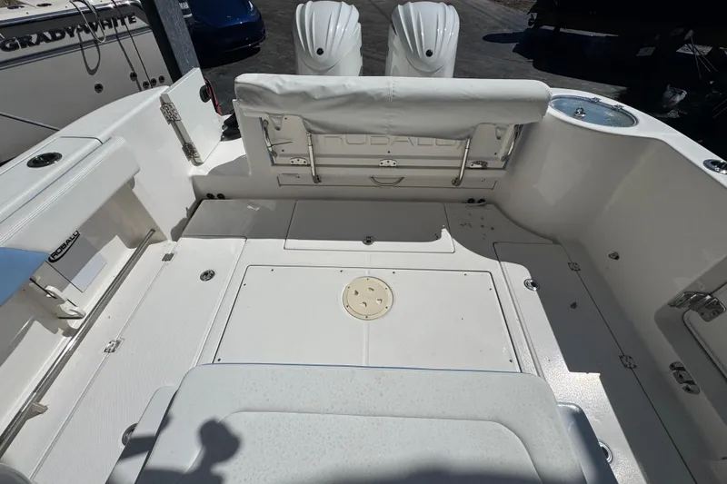 Slide: The Image of 2023 Robalo R302 Center Console boat interior with seating and storage compartments. - 7
