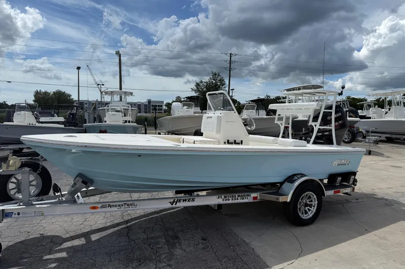 The Image of 2026 Hewes 16 Redfisher boat on trailer under cloudy sky at marina. - 1