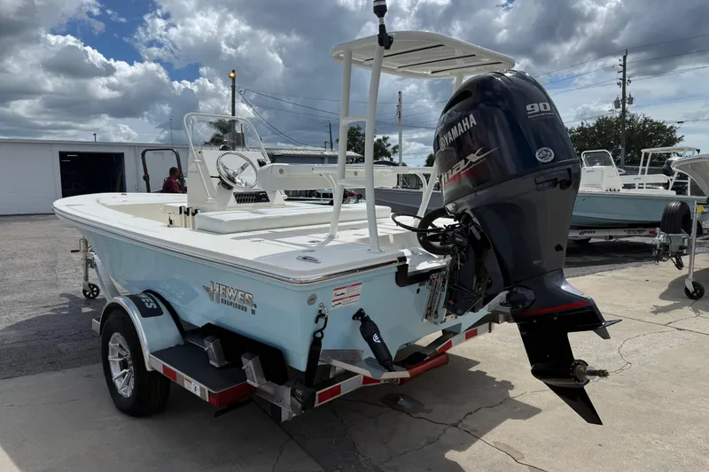 Slide: The Image of 2026 Hewes 16 Redfisher boat with Yamaha engine on trailer under cloudy sky. - 3