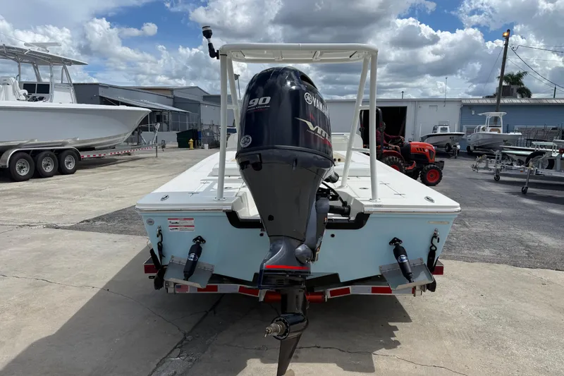 Slide: The Image of 2026 Hewes 16 Redfisher boat with Yamaha 90 engine at a marina. - 4