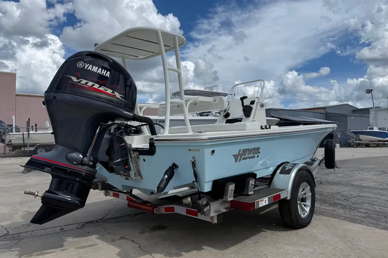 Slide: The Image of 2026 Hewes 16 Redfisher boat with Yamaha VMAX engine on trailer, parked outdoors. - 5