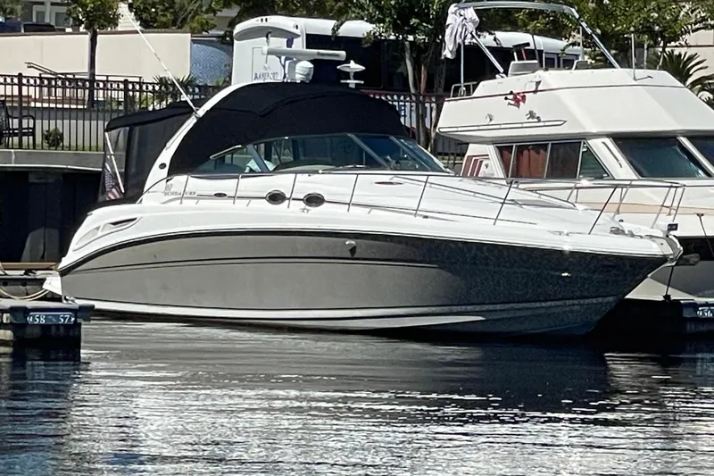 Slide: The Image of 2006 Sea Ray 360 Sundancer yacht docked at marina, featuring sleek design and modern amenities. - 0