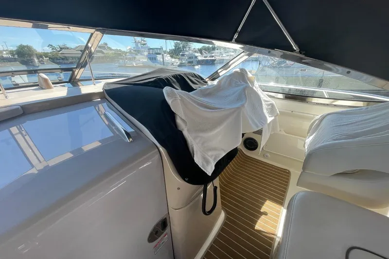 Slide: The Image of Interior of 2006 Sea Ray 360 Sundancer with helm, leather seating, and wooden accents. - 16