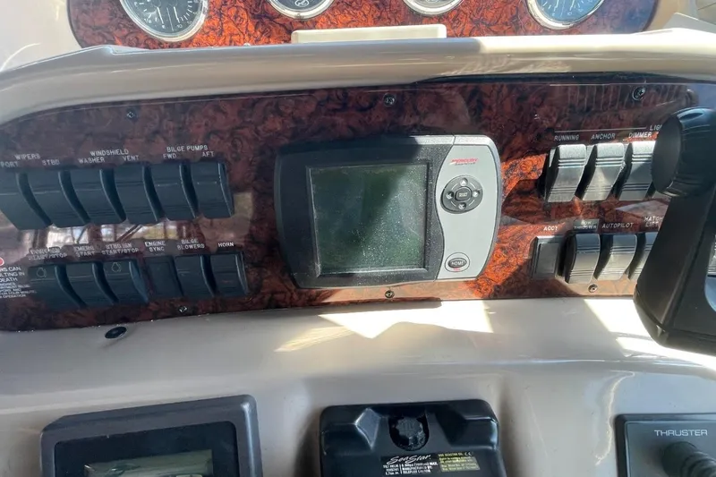 Slide: The Image of Interior of 2006 Sea Ray 360 Sundancer yacht with white seating and wood flooring. - 17