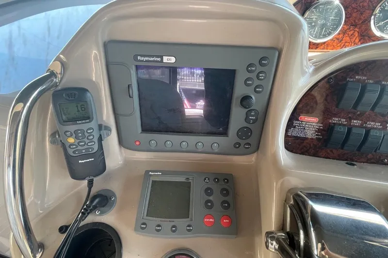 Slide: The Image of Interior of 2006 Sea Ray 360 Sundancer yacht with white seating and wood flooring. - 18