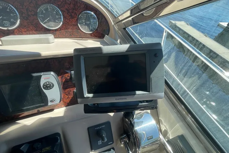 Slide: The Image of 2006 Sea Ray 360 Sundancer interior with white seating and wood-patterned flooring. - 20