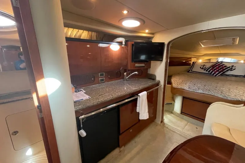 Slide: The Image of Interior of 2006 Sea Ray 360 Sundancer yacht with kitchenette and cozy sleeping area. - 25